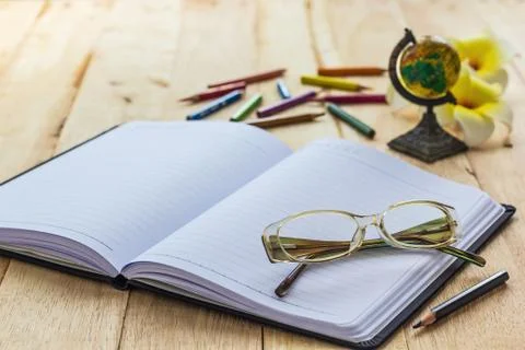 Glasses on notebook Stock Photos