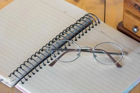 Glasses on a notebook. Stock Photos