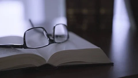 Glasses on old book - film style Stock Footage