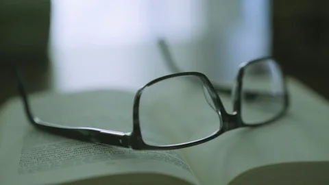 Glasses on old book - film style Stock Footage