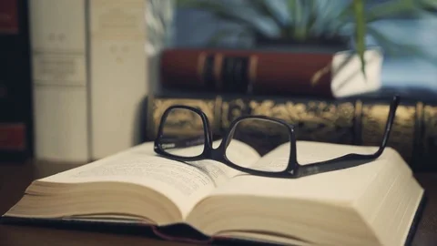 Glasses on old book - film style Stock Footage