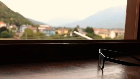 Glasses ona window with mountains background Stock Footage 93327610