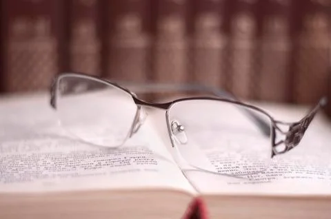 Glasses on open book Stock Photos