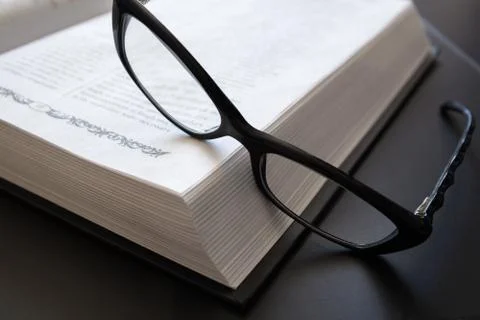 Glasses on the Open Book. Stock Photos