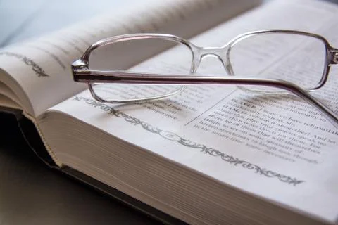 Glasses on the Open Book. Stock Photos