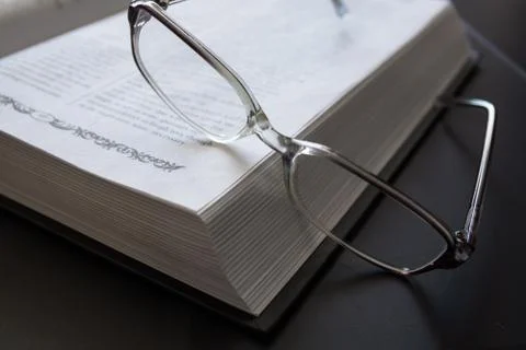 Glasses on the Open Book. Stock Photos
