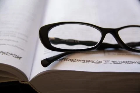 Glasses on the Open Book. Stock Photos
