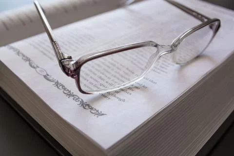 Glasses on the Open Book. Stock Photos