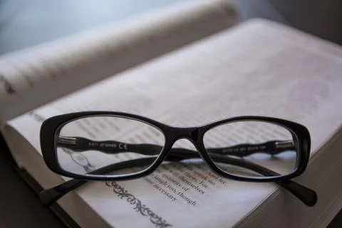 Glasses on the Open Book. Stock Photos