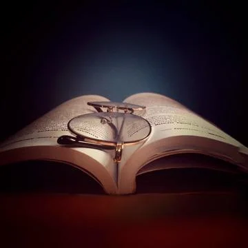 Glasses on an open book. Stock Photos