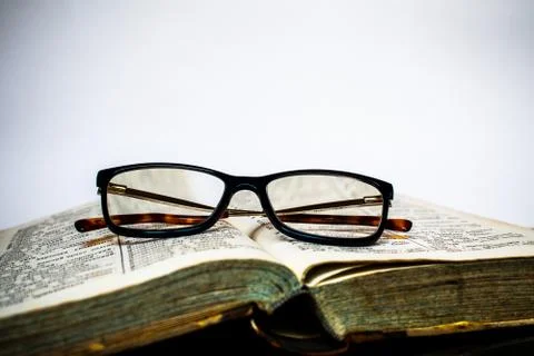 Glasses on the open old book Stock Photos