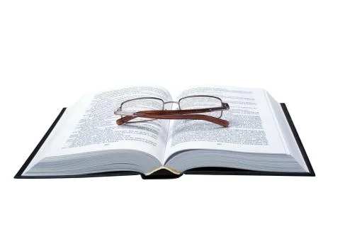 Glasses on the opened book Stock Photos