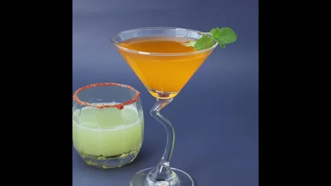Glasses of orange juice and grape juice garnished with mint leaves ,salt n .. Stock Footage 334728817
