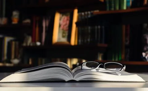 Glasses on the pages Stock Photos