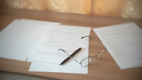 Glasses, papers documents and pen on the table. Stock Footage 88721850