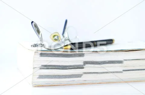 Glasses with pen and book Stock Photos