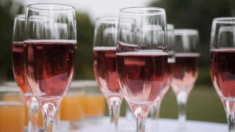 Glasses with pink champagne inside Stock Footage 123014162