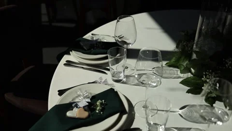 Glasses plates and kitchen utensils on a table in a restaurant for a holiday Stock Footage 311760869