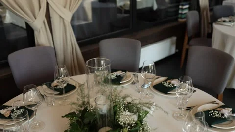 Glasses plates and kitchen utensils on a table in a restaurant for a holiday Stock Footage 311760972