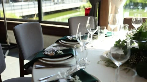 Glasses plates and kitchen utensils on a table in a restaurant for a holiday Stock Footage 311762007