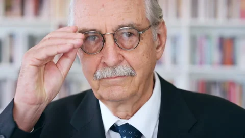 Glasses, professor and face of man in library for about us, course lecturer and Stock Footage 336697461