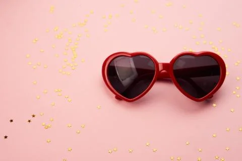 Glasses with red frames on a pink background Stock Photos