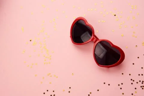 Glasses with red frames on a pink background Stock Photos