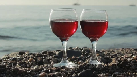 Glasses of red wine on the beach Stock Footage 82337213