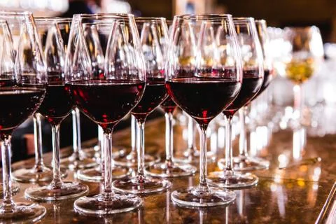 Glasses with red wine on blurred background. Stock Photos