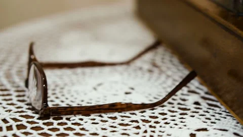 Glasses for sight. Elderly hands take glasses for sight Stock Footage 101126679