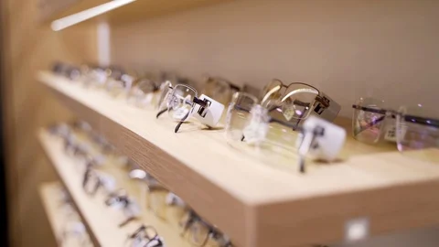 Glasses for sight. Sunglasses in a store. A collection of frames on the store Stock Footage 103409663