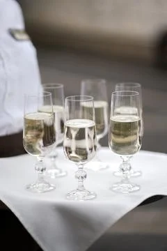Glasses of sparkling wine on a serving table during a festive reception or we Stock Photos