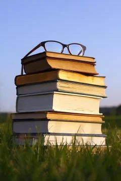 Glasses on stack of books outside Stock Photos