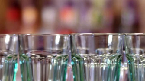 Glasses standing in a row on a bar counter Stock Footage 129663657