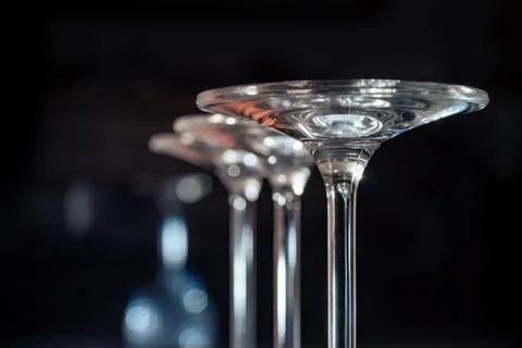 Glasses standing upside down on a dark background Stock Photos