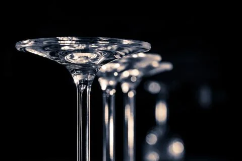 Glasses standing upside down on a dark background Stock Photos