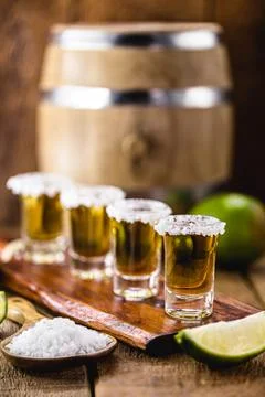 Glasses of tequila on the bar table, served with salt and lemon Stock Photos
