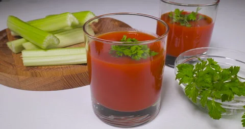 Glasses of tomato juice on table Stock Footage 167663585