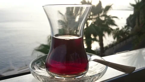 Glasses Of Turkish Tea On The Table With Anchored Sailing Yacht In The Sea Stock Footage 91709252