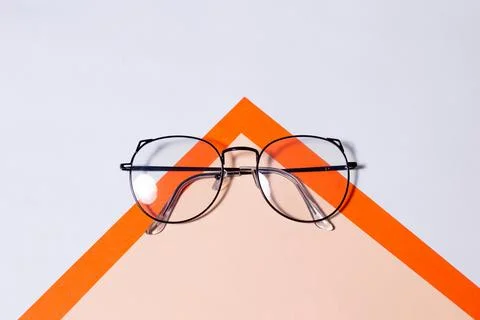 Glasses for vision, in black frames on a colored background Stock Photos