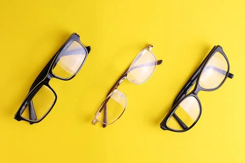 Glasses for vision correction on a colored background with space for text Stock Photos
