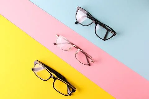 Glasses for vision correction on a colored background with space for text Stock Photos