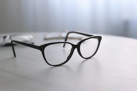 Glasses for vision correction on a table in the interior of the room Stock Photos