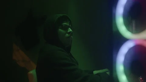 Glasses-wearing programmer or hacker working on desktop computer with green.. Stock Footage 234116486