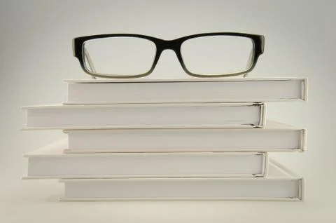 Glasses on white books Stock Photos