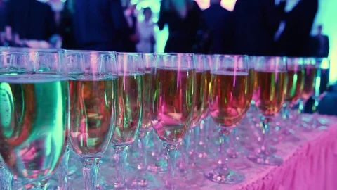 Glasses with white sparkling wine in row at restaurant event Stock Footage 84145265