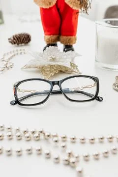 Glasses on a white table surrounded by beads Stock Photos