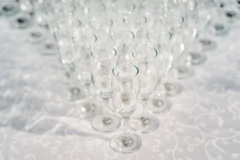 Glasses of white wine in a row on the table in pyramid Stock Photos