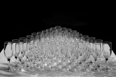 Glasses of white wine in a row on the table in pyramid Stock Photos