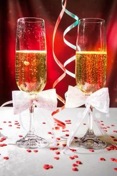 Glasses of wine and serpentine on bright red background Stock Photos